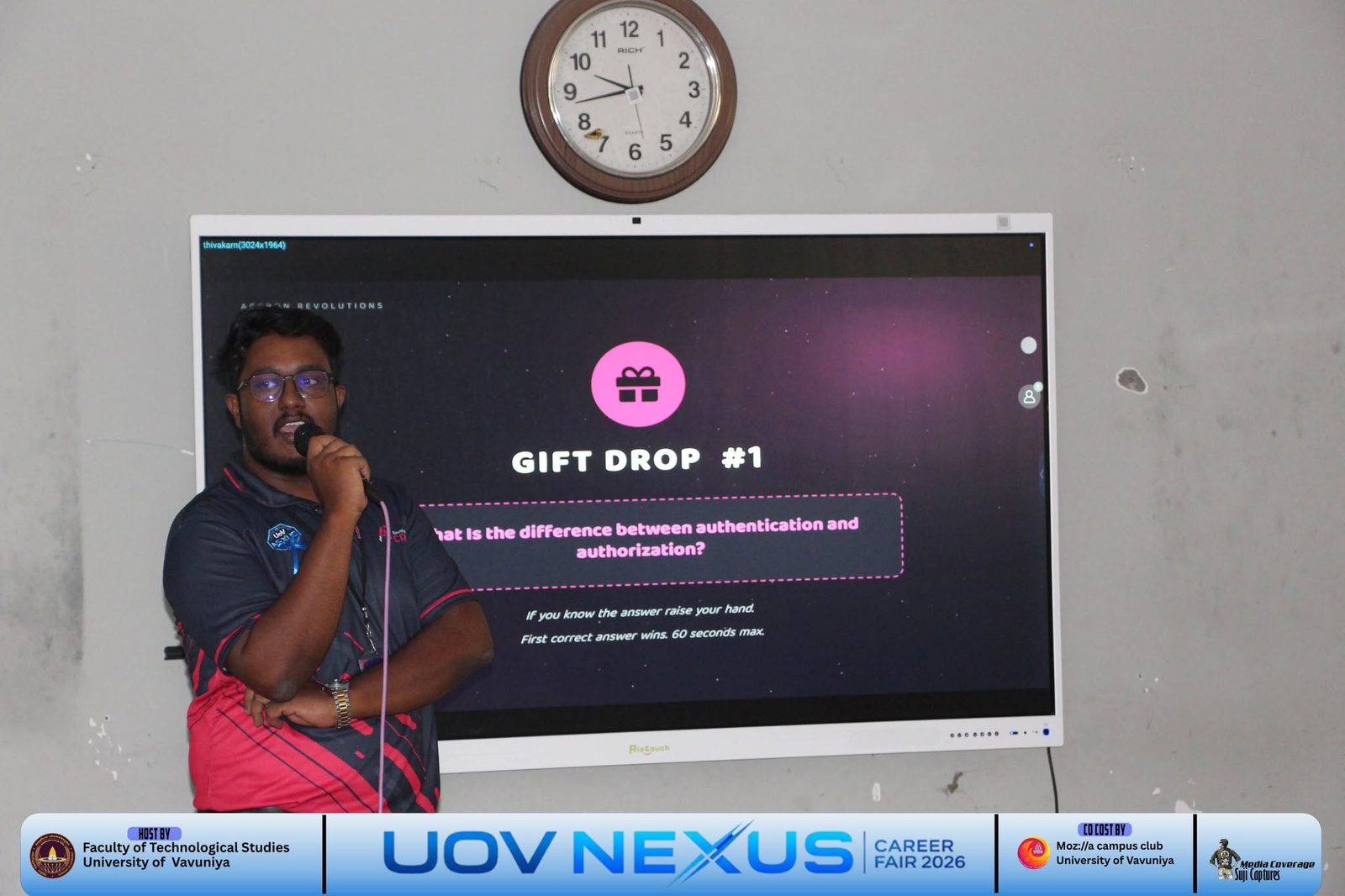 Accron Revolutions speaker running a gift drop quiz question on authentication versus authorization at the University of Vavuniya session